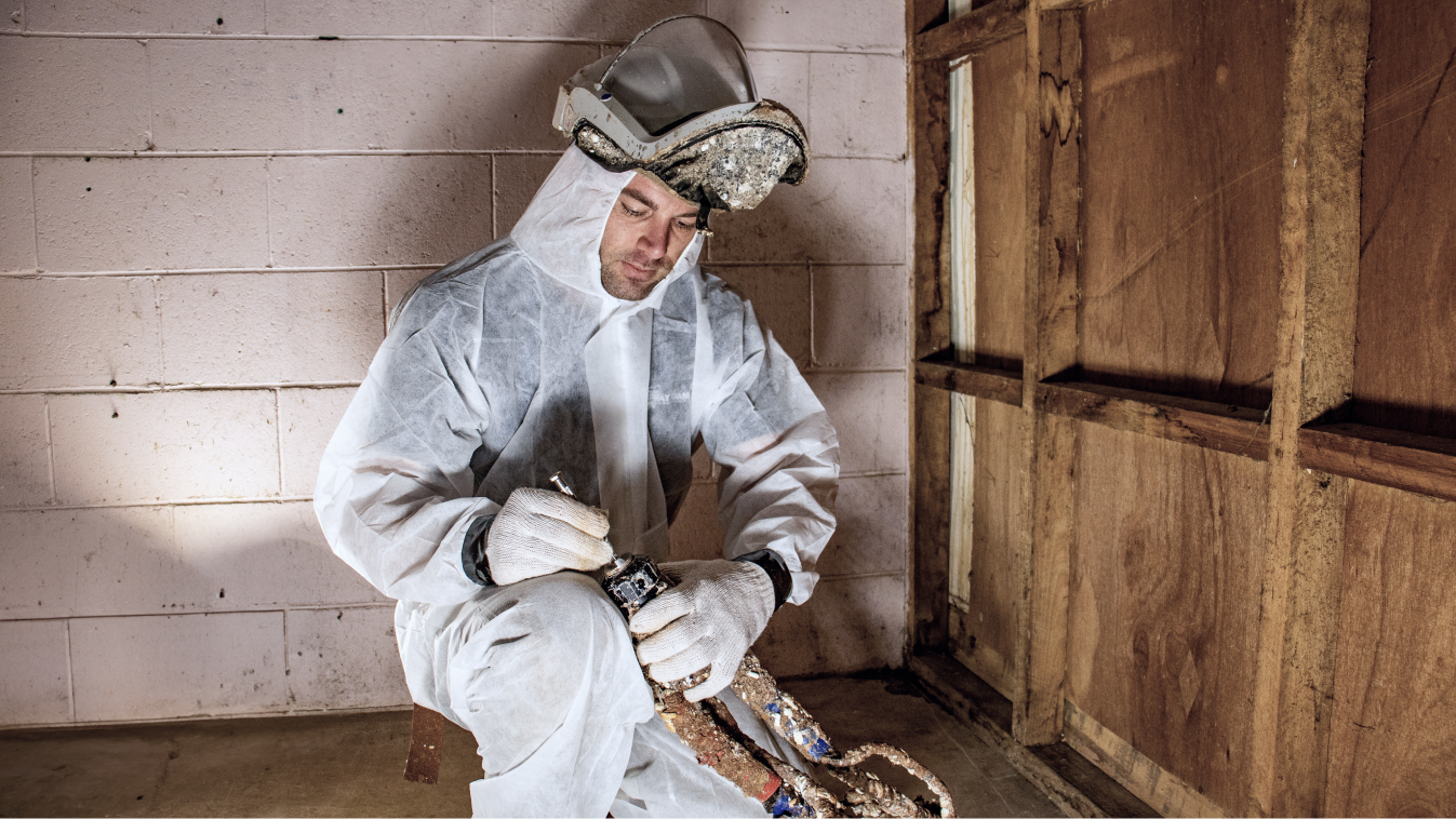 Installer wearing PPE and attaching a spray nozzle