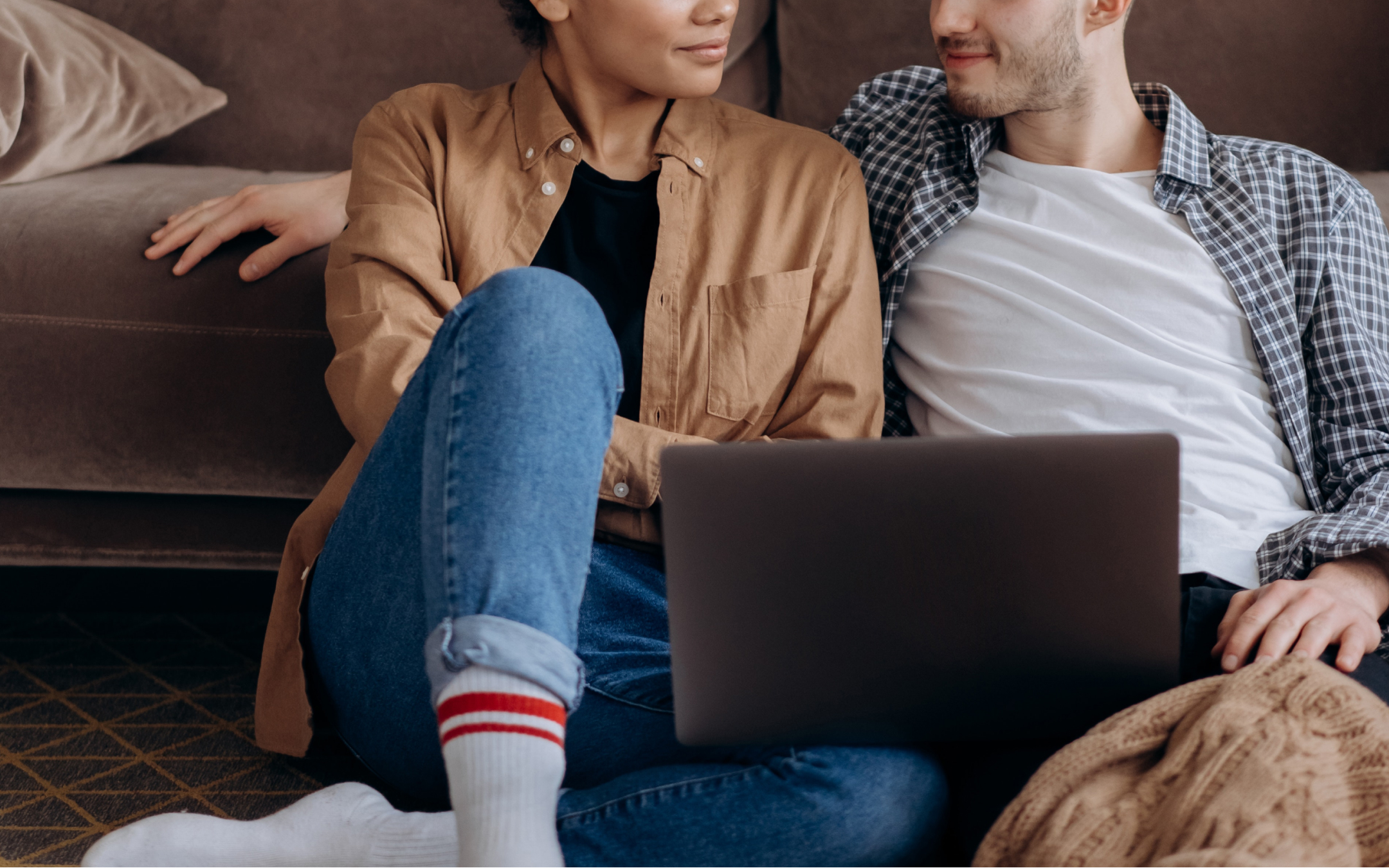 Couple relaxing on their living room floor