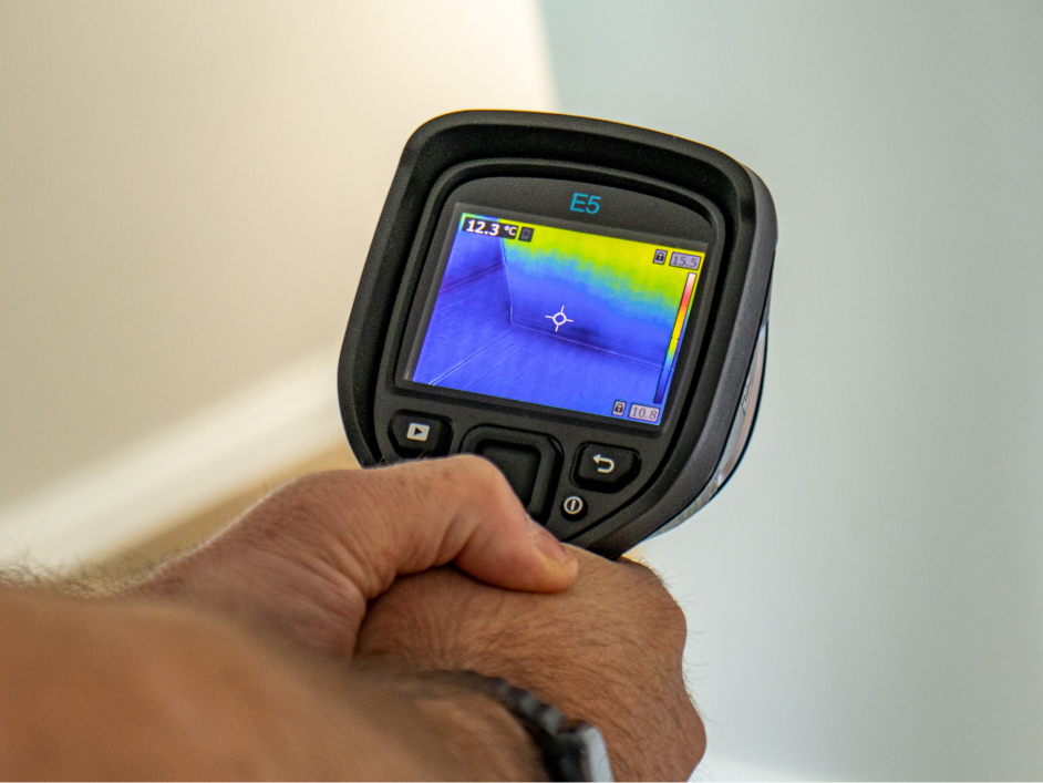 Man holding thermal imaging camera