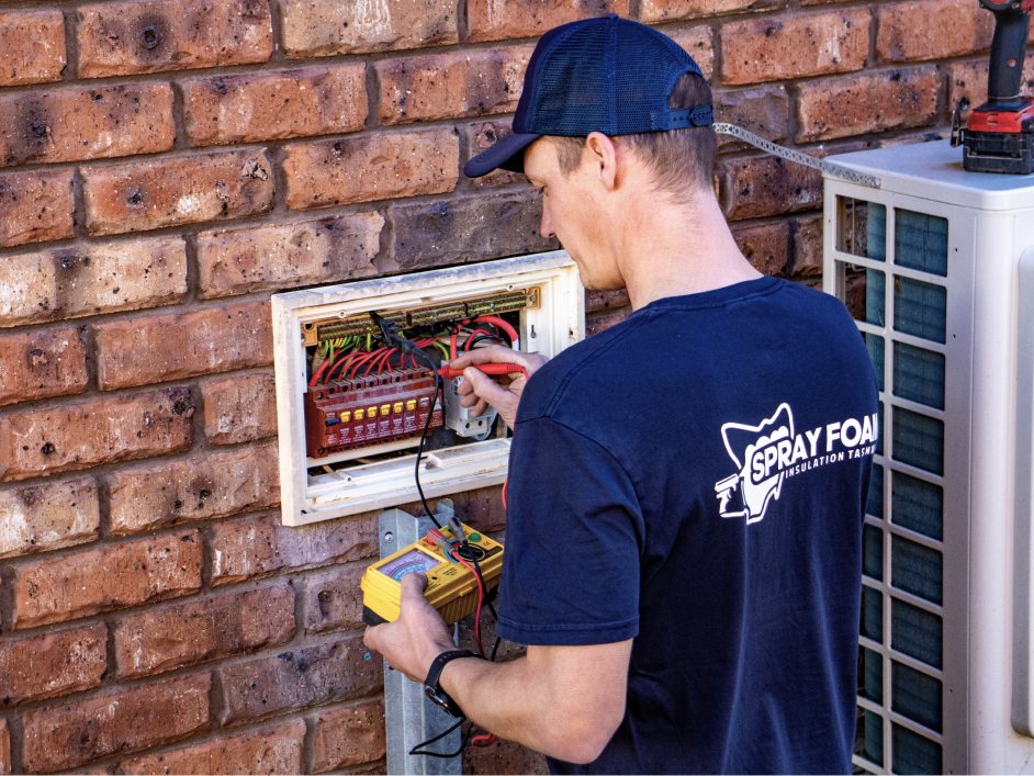 Man checking home's switchboard