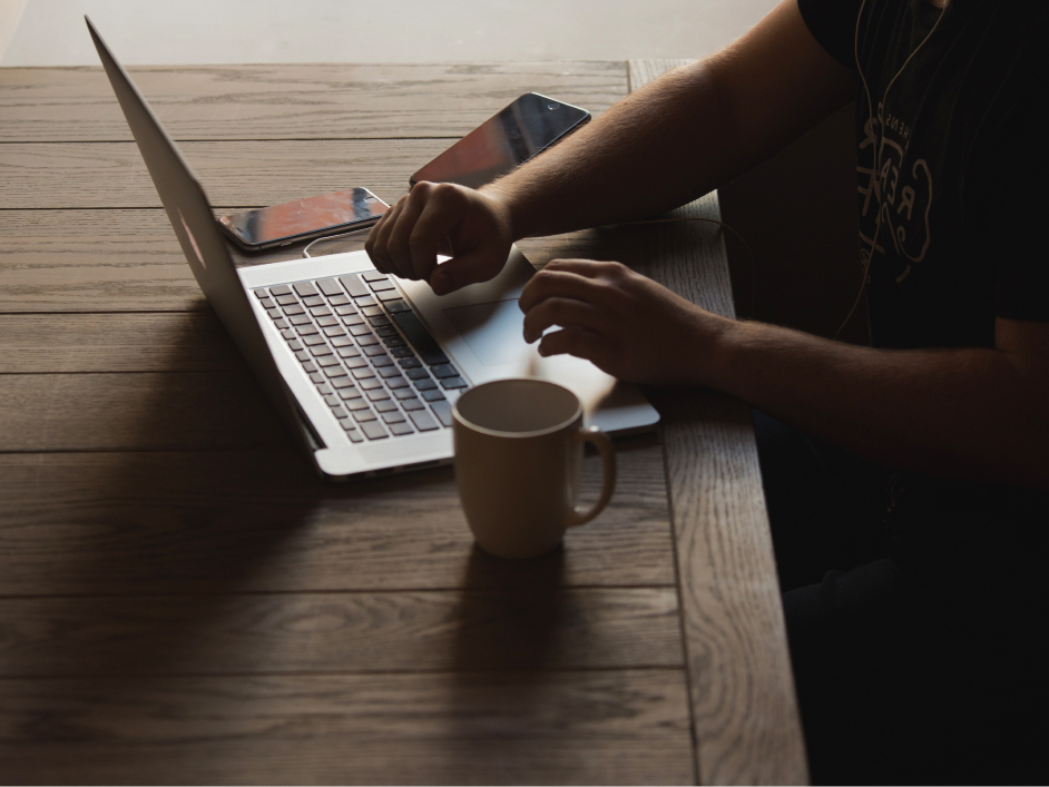 Person sitting at the table with their laptop