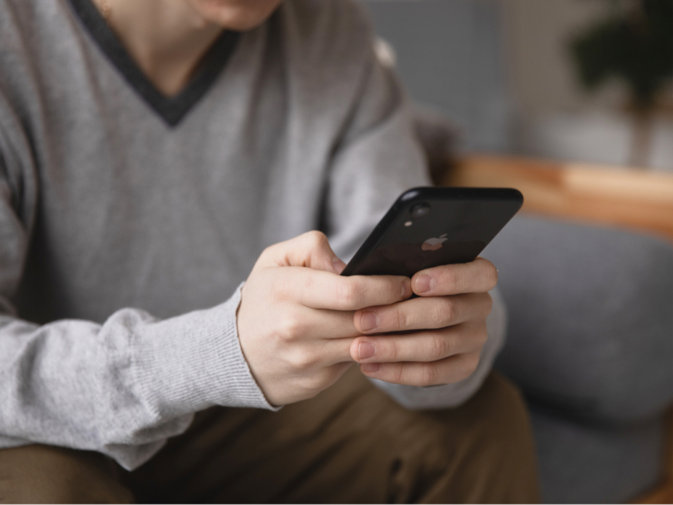 Person holding their mobile phone