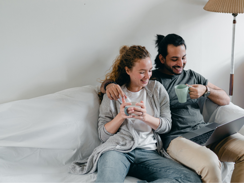 Couple sitting on couch smiling