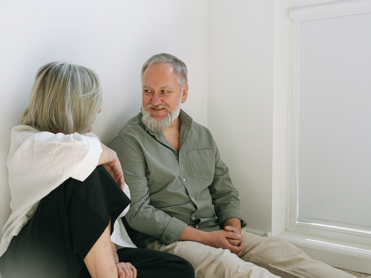 Elderly couple sitting on the floor