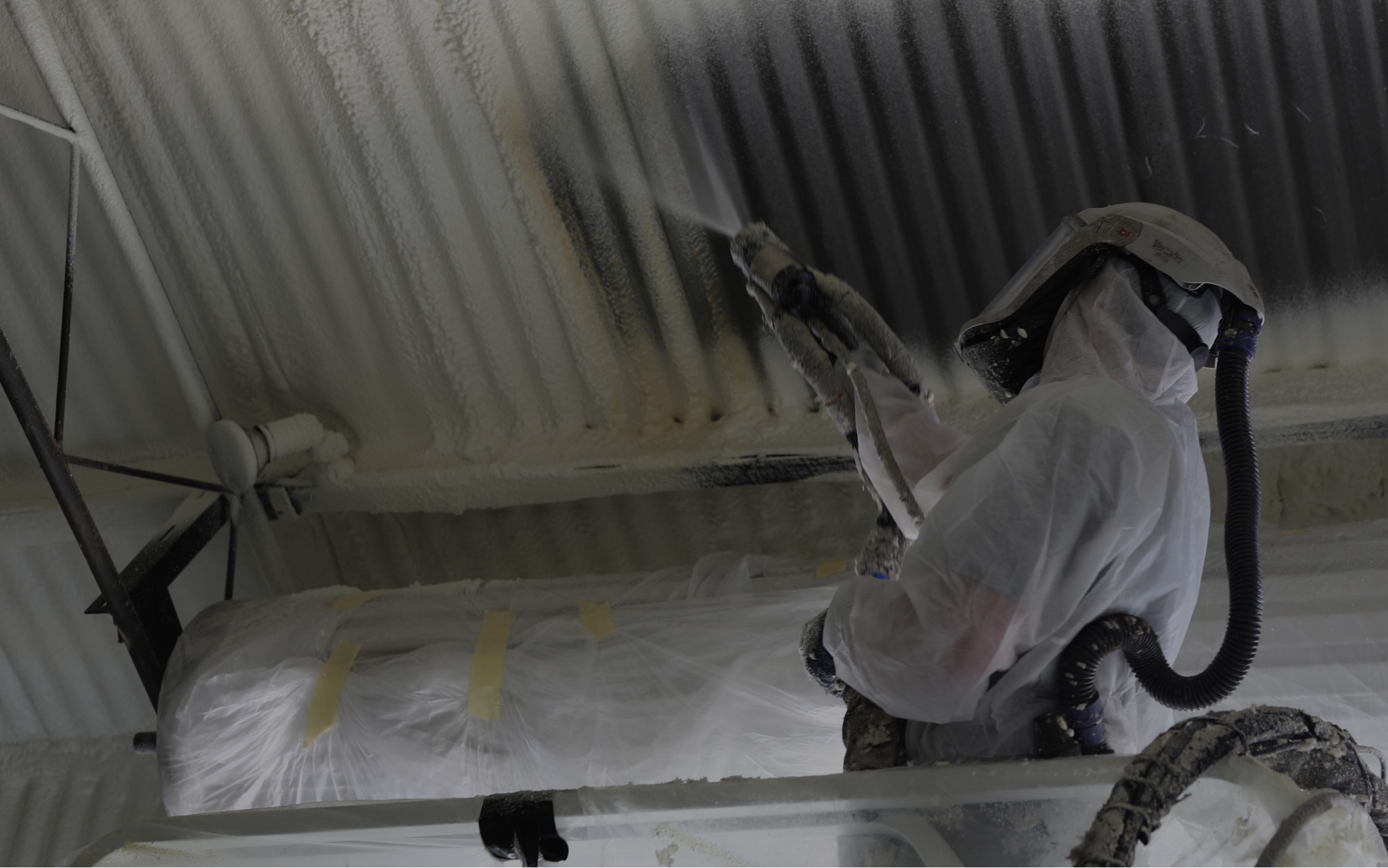 Worker spraying inside of warehouse